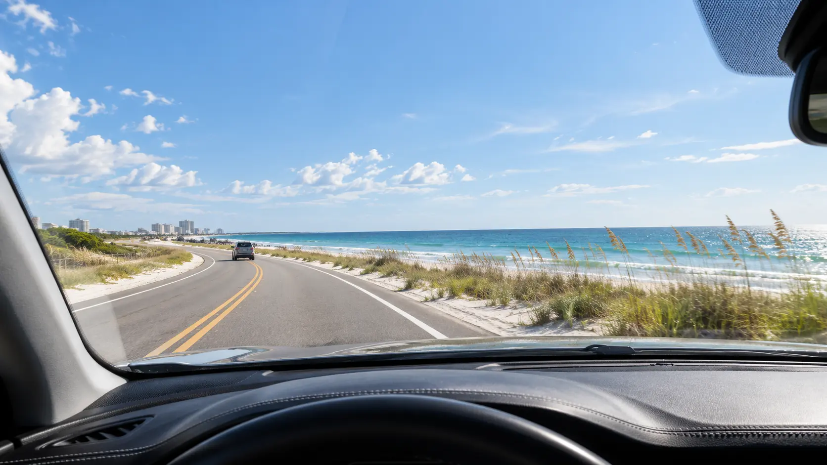 Clear coastal road view through a protected windshield